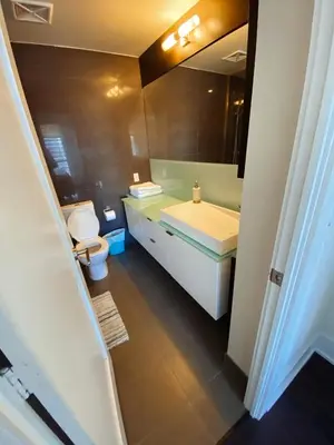 a bathroom with a sink and a toilet and a mirror at Luxury condo on CN TOWER in Toronto
