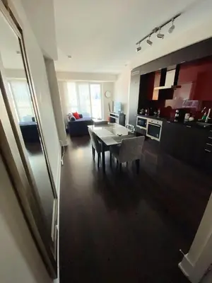 a kitchen and living room with a table and chairs at Luxury condo on CN TOWER in Toronto