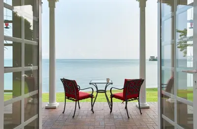 a patio with a table and two chairs and the ocean at Somerset - A Private Retreat in Niagara on the Lake