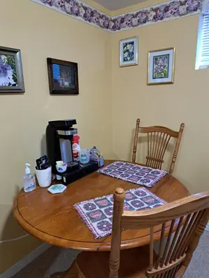 a dining room table with a table and a television at Carrousel Bed & Breakfast in Cayuga