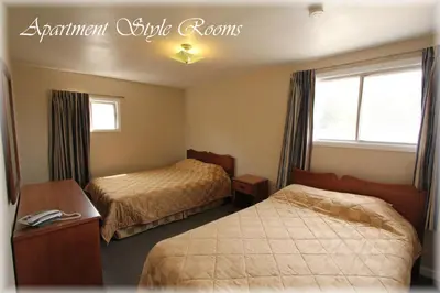 a hotel room with two beds and a window at Lotus Motel in Cobourg