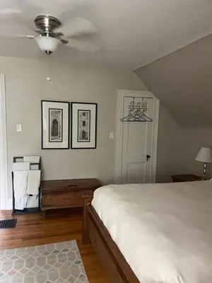 a bedroom with a bed and a ceiling fan at Cottage on Caledonia Bed & Breakfast in Stratford