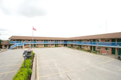 an empty parking lot in front of a building at Knights Inn Lindsay in Lindsay