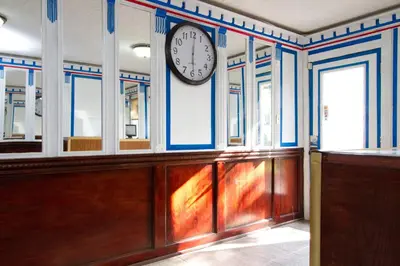 a clock on a wall in a room withwindows at Knights Inn Lindsay in Lindsay