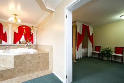 a large bathroom with a sink and a mirror at Knights Inn Lindsay in Lindsay