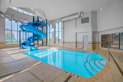 a swimming pool with a slide in a building at Holiday Inn Express & Suites - Woodstock, ON CANADA in Woodstock