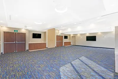 a large room with two monitors on the wall at Holiday Inn Express & Suites - Woodstock, ON CANADA in Woodstock