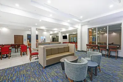 a lobby with a couch and chairs and tables at Holiday Inn Express & Suites - Woodstock, ON CANADA in Woodstock