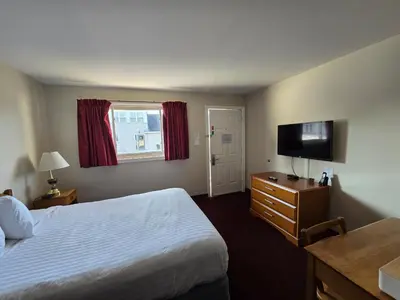 a hotel room with a bed and a flat screen tv at Travelodge by Wyndham Port Elgin in Port Elgin
