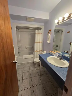 a bathroom with a sink and a toilet and a shower at Travelodge by Wyndham Port Elgin in Port Elgin