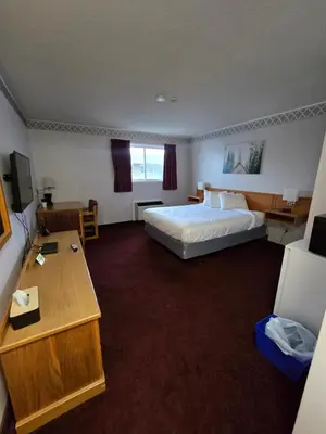a hotel room with a bed and a desk at Travelodge by Wyndham Port Elgin in Port Elgin