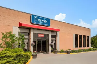 a store with a sign on the side of a building at Travelodge by Wyndham Lindsay in Lindsay