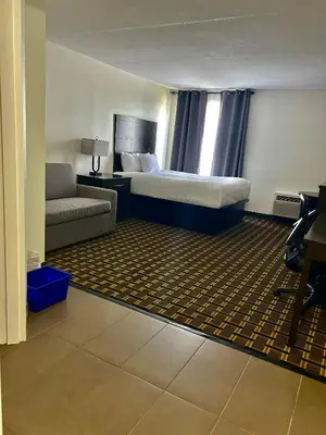 a hotel room with a bed and a couch at Travelodge by Wyndham Lindsay in Lindsay