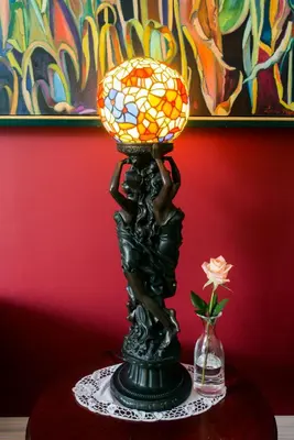 a lamp on a table with a flower in a vase at Historic Lyons House in Niagara on the Lake
