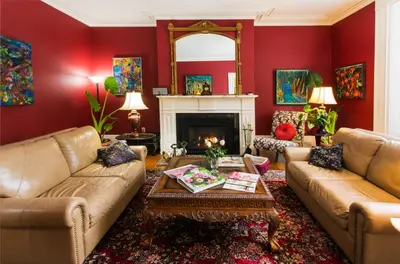 a living room with two couches and a fireplace at Historic Lyons House in Niagara on the Lake