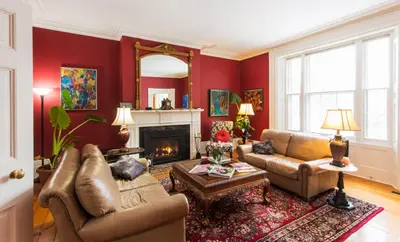 a living room with a couch and a fireplace at Historic Lyons House in Niagara on the Lake