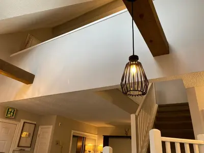 a light hanging from a ceiling in a house at Blue Mountain 2 Story Studio Loft in Blue Mountains