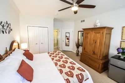 a bedroom with a large bed and a ceiling fan at Graystone Bed & Breakfast in Niagara on the Lake