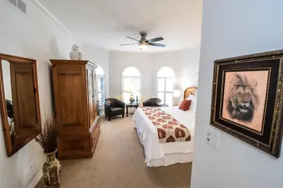 a bedroom with a bed and a painting of a dog at Graystone Bed & Breakfast in Niagara on the Lake