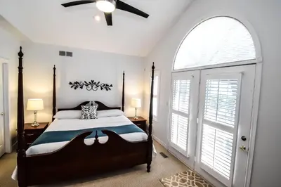 a bedroom with a bed and a ceiling fan at Graystone Bed & Breakfast in Niagara on the Lake