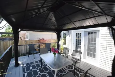 a screened in porch with a table and chairs at Graystone Bed & Breakfast in Niagara on the Lake