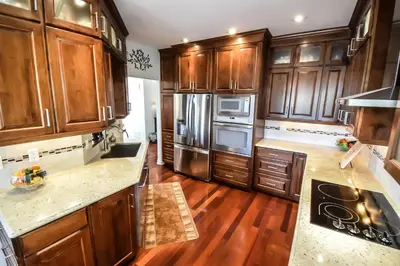 a kitchen with wooden cabinets and stainless steel appliances at Graystone Bed & Breakfast in Niagara on the Lake