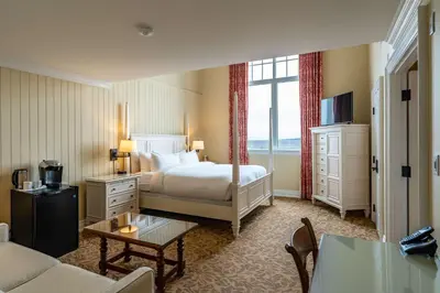 a hotel room with a bed and a couch at The Inn at Cobble Beach in Kemble