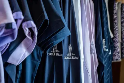 a bunch of shirts are hanging in a closet at The Inn at Cobble Beach in Kemble