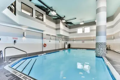 a swimming pool in a large room with columns at Best Western Plus Cambridge Hotel in Cambridge