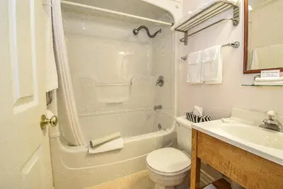 a white bathroom with a toilet and a sink at Blairpen House Country Inn in Niagara on the Lake