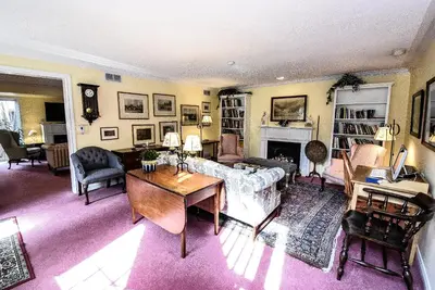 a living room with a couch and a table at Blairpen House Country Inn in Niagara on the Lake