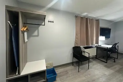 a room with a desk and a chair and a table at Travelodge by Wyndham Bracebridge in Bracebridge