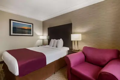 a hotel room with a bed and a couch at Best Western Little River Inn in Simcoe