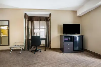 a room with a television and a desk and a chair at Best Western Little River Inn in Simcoe