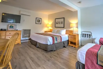 a hotel room with two beds and a table at Lakeview Motel in Haliburton