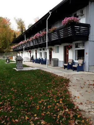 a building with a balcony with flowers on it at Lakeview Motel in Haliburton