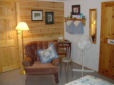 a living room with a chair and a lamp at Sunny Rock Bed & Breakfast in Minden