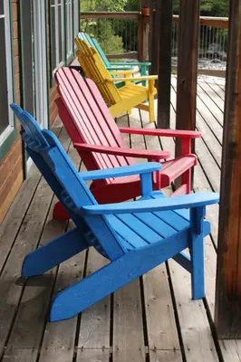 a row of colorful chairs sitting on a porch at Sunny Rock Bed & Breakfast in Minden