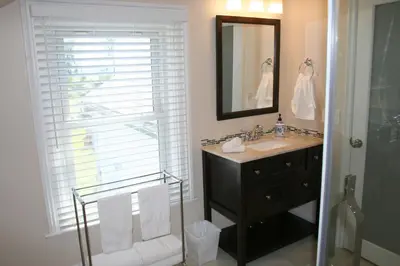 a bathroom with a sink and a mirror at Hadovka Lakeside Inn in Wellington