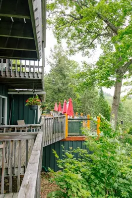 a fence with red umbrellas on it next to a house at Heather Lodge in Minden