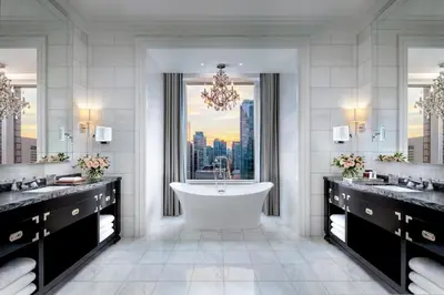 a bathroom with a tub and a view of a city at The St. Regis Toronto in Toronto