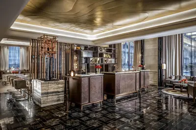 a lobby of a hotel with a bar and chairs at The St. Regis Toronto in Toronto