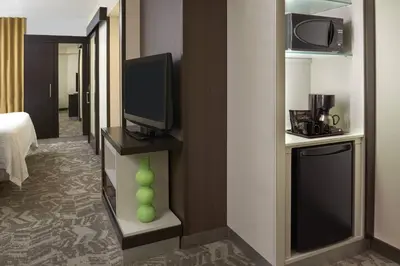 a hotel room with a television and a room with a bed at SpringHill Suites by Marriott Toronto Vaughan in Vaughan