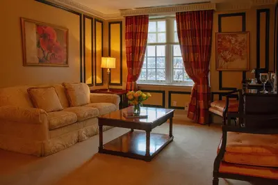 a living room with a couch and a table at Windsor Arms Hotel in Toronto
