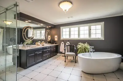 a bathroom with a tub and two sinks and a shower at Tailwinds B&B in Erin