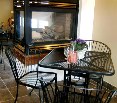 a table and chairs in front of a fireplace at Dominion Hotel in Minden