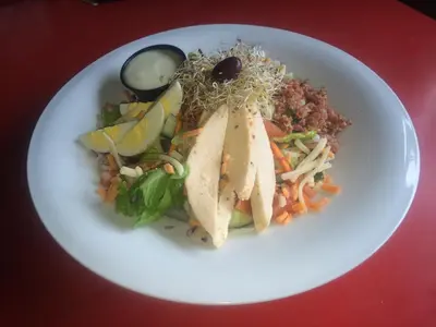 a plate of food with a sandwich and a salad at Dominion Hotel in Minden