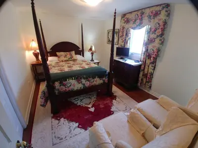 a living room with a bed and a couch at TwiningRetreat in Niagara on the Lake
