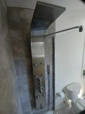 a shower with a glass door in a bathroom at TwiningRetreat in Niagara on the Lake