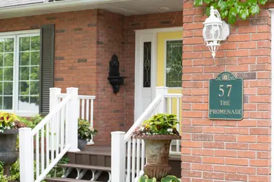 a brick house with a sign on the side of it at TwiningRetreat in Niagara on the Lake